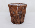 Handwoven wicker trash can with natural brown finish, ideal for cozy home decor and rustic bathroom or kitchen use.