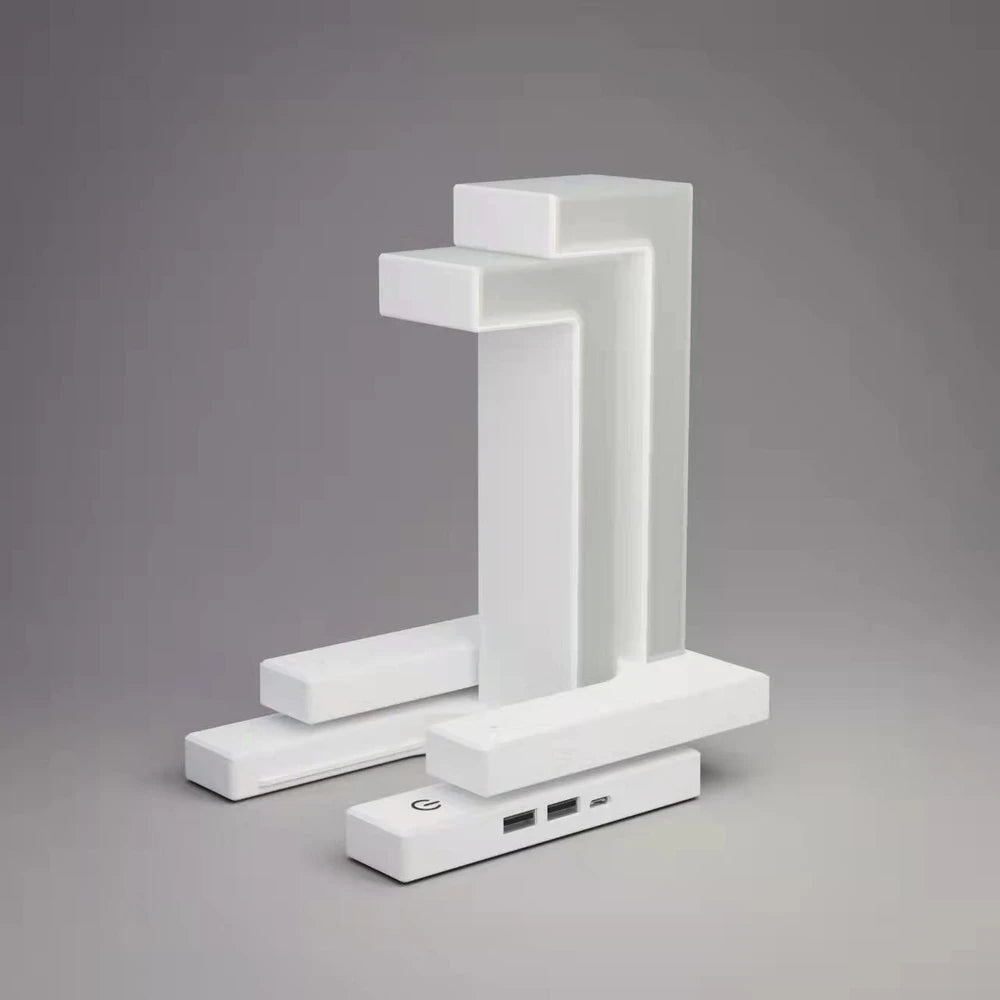 Modern white geometric desk lamp with USB ports, minimalist design for cozy home office lighting