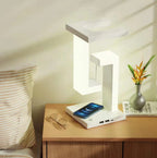 Modern white LED bedside lamp with wireless phone charger and USB ports on wooden nightstand