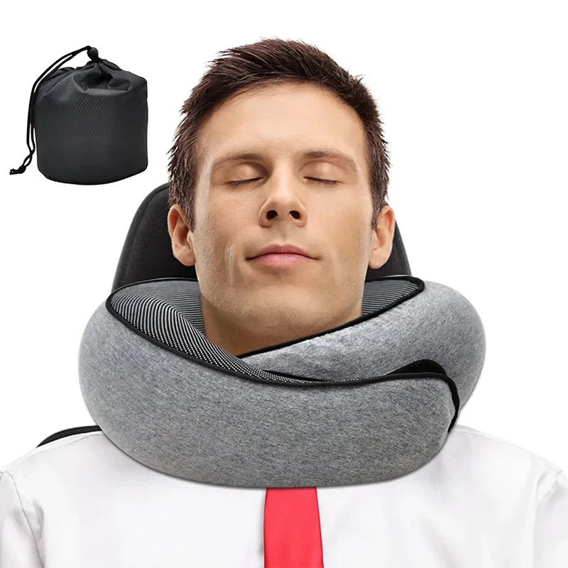 Man sleeping comfortably with gray memory foam travel neck pillow and carry bag