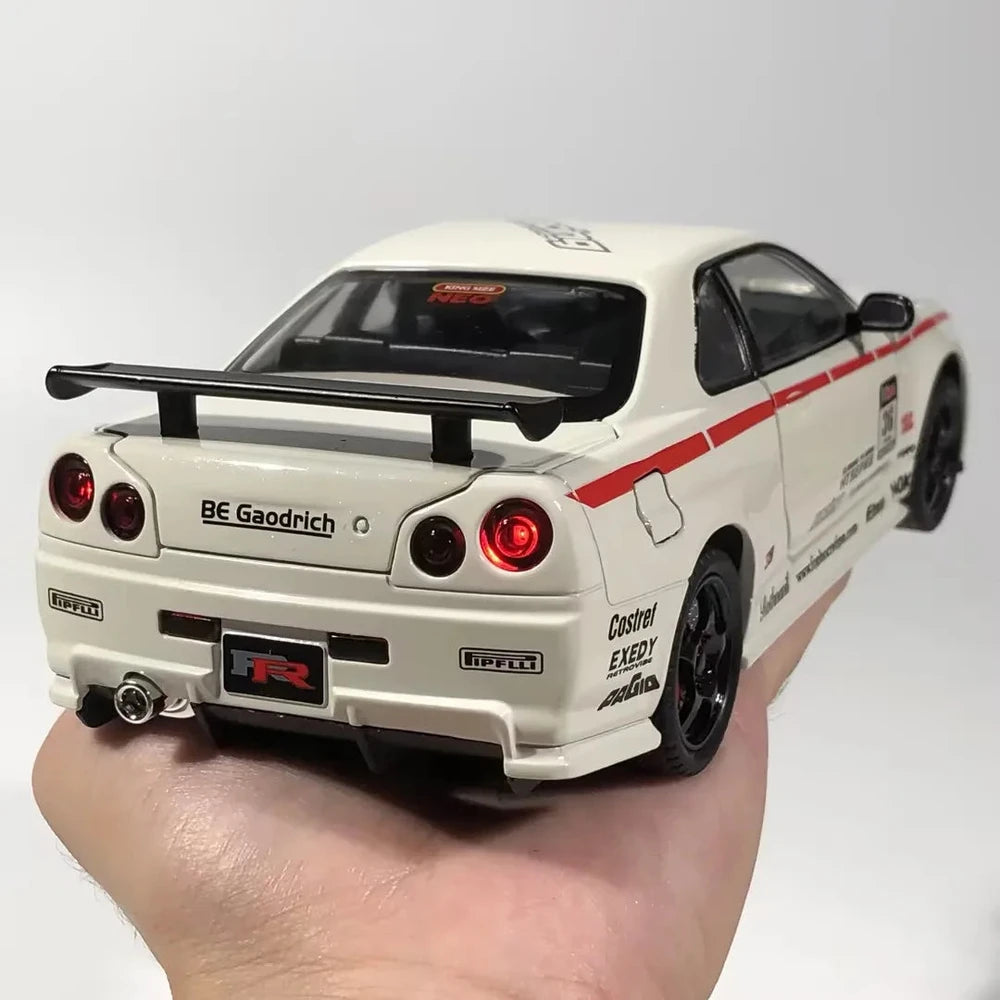 White Nissan GT-R diecast model with red racing stripes, rear spoiler, and detailed decals held in hand