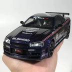 Sparkly black diecast sports car model with racing decals, held in hand, detailed toy vehicle