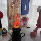 Glowing orange lava lamp with cute character inside, cozy desk decor with playful figurines