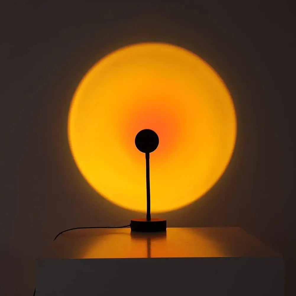 Warm sunset projection lamp casting golden glow on wall, cozy ambient lighting for bedroom or living room