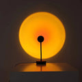 Warm sunset projection lamp casting golden glow on wall, cozy ambient lighting for bedroom or living room