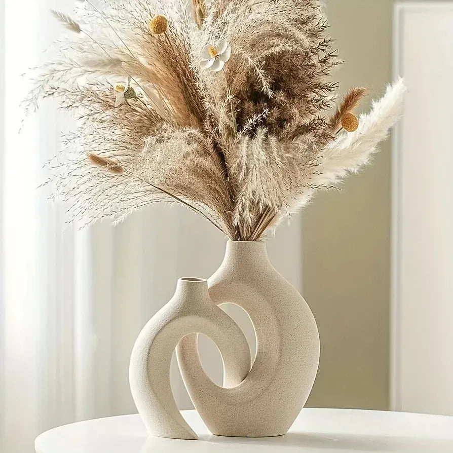 Modern ceramic vase with dried pampas grass and white blooms, minimalist home decor accent