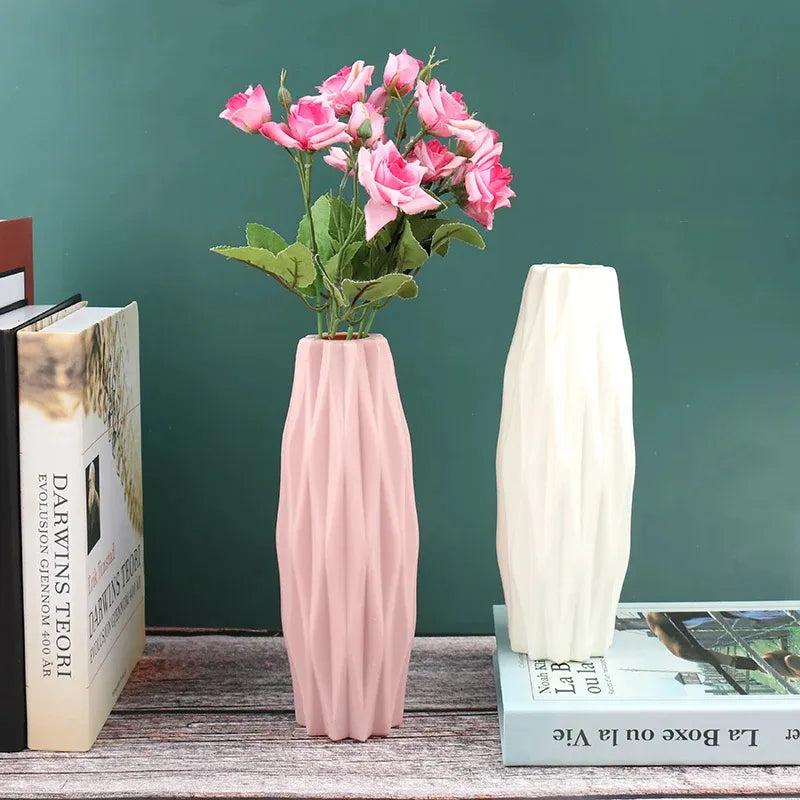 Pink and white textured vases with pink roses, styled on wooden shelf with books for home decor