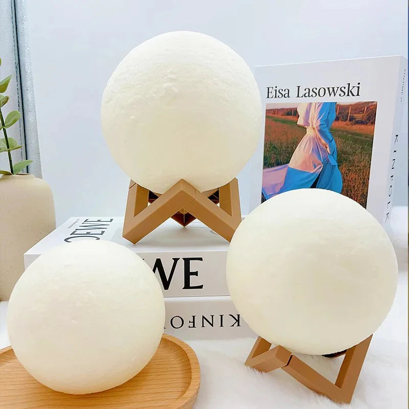 Three moon-shaped LED lamps on wooden stands, cozy bedroom decor with soft glow