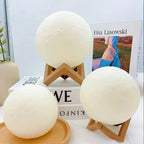 Three moon-shaped LED lamps on wooden stands, cozy bedroom decor with soft glow