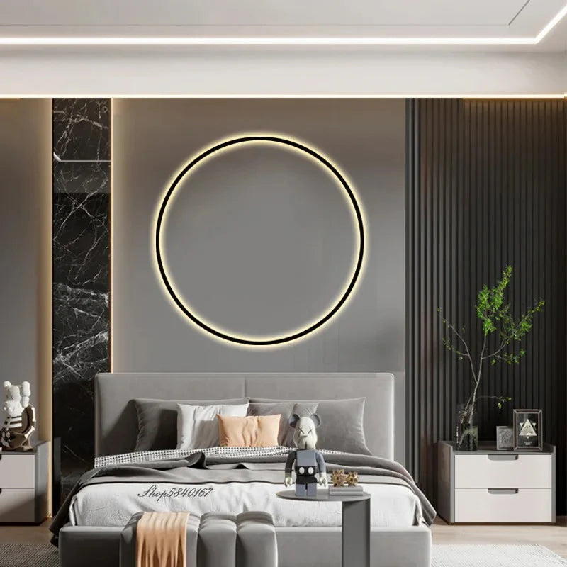 Modern bedroom with round LED wall mirror, gray bedding, and sleek nightstands for cozy luxury decor