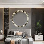 Modern bedroom with round LED wall mirror, gray bedding, and sleek nightstands for cozy luxury decor