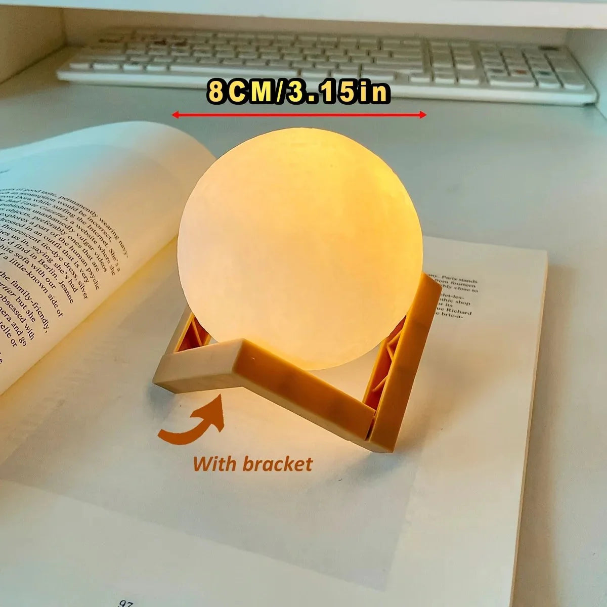 8cm glowing moon lamp with wooden bracket on open book, cozy desk decor