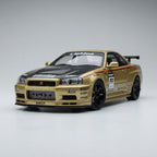 Gold Nissan GT-R diecast model with racing decals, carbon fiber hood, and black rims