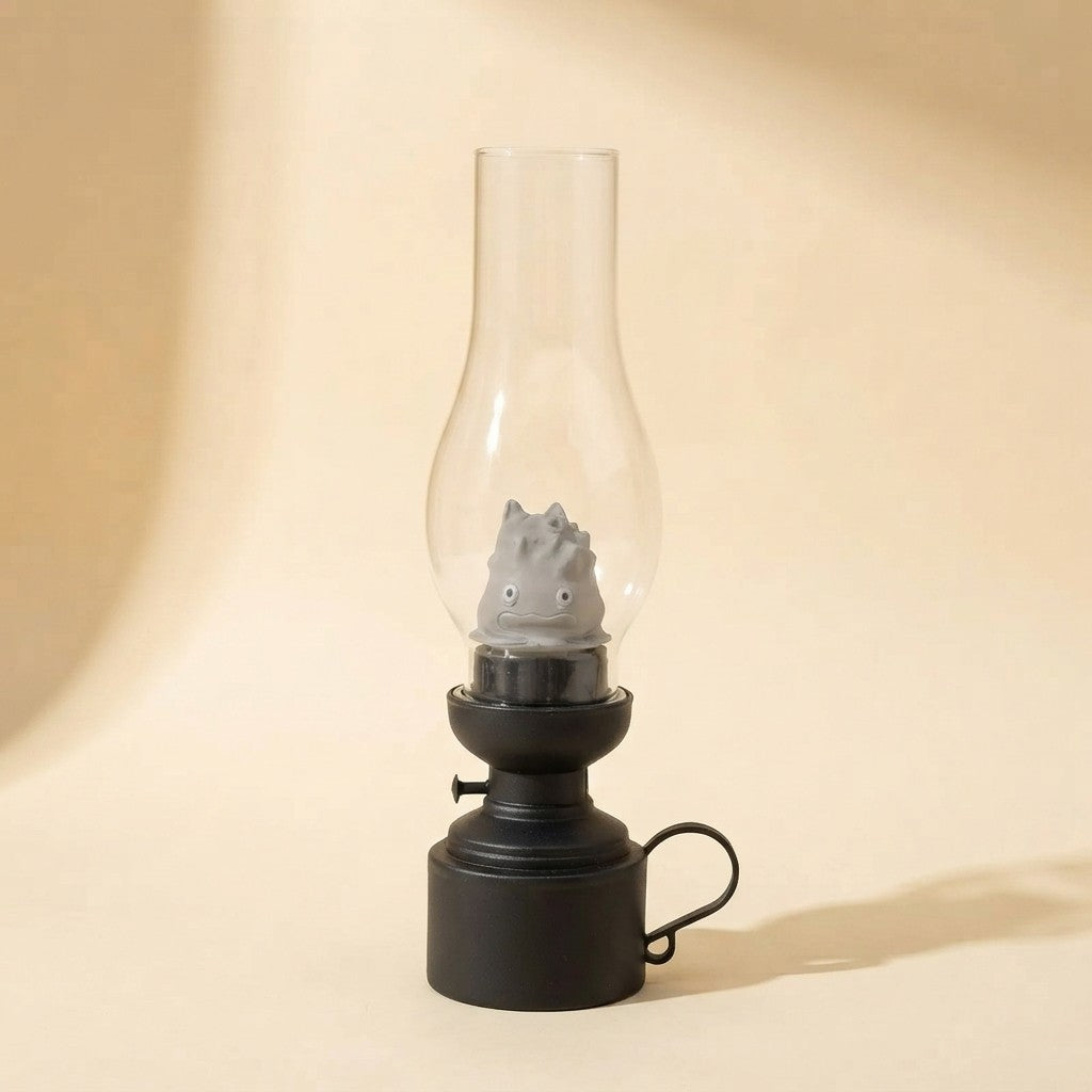 Cute gray creature inside vintage-style glass lantern with black base, cozy home decor accent