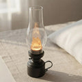 Cute flame-shaped night light in glass lantern, cozy bedroom decor with soft glow