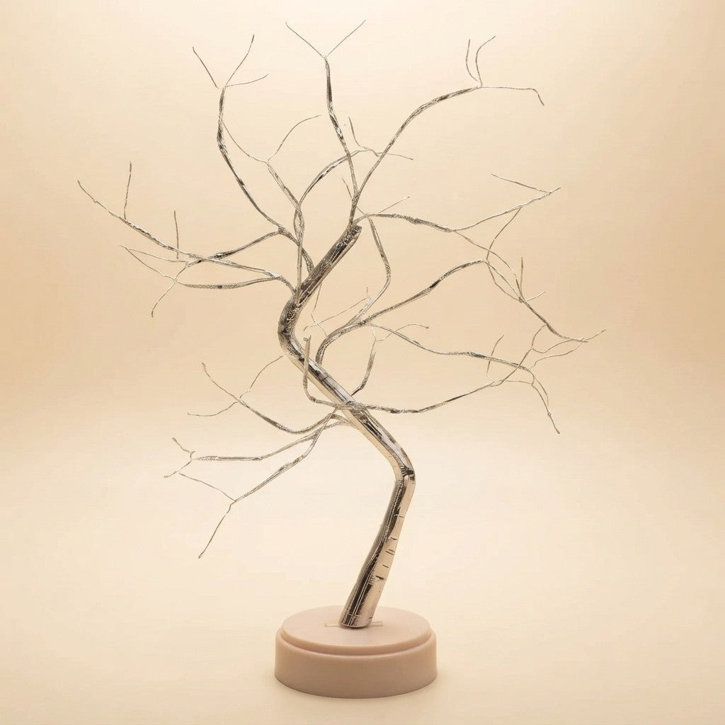 Silver wire tree sculpture with curved trunk and branching limbs on beige base, modern home decor